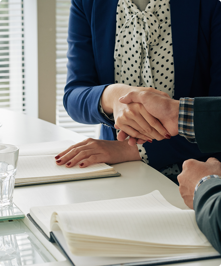 Handshake across a desk